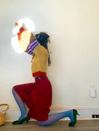 a woman is holding a light up in her hands