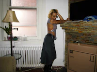 a woman standing in front of a fireplace